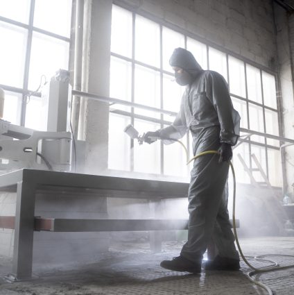 man-spraying-powder-paint-full-shot